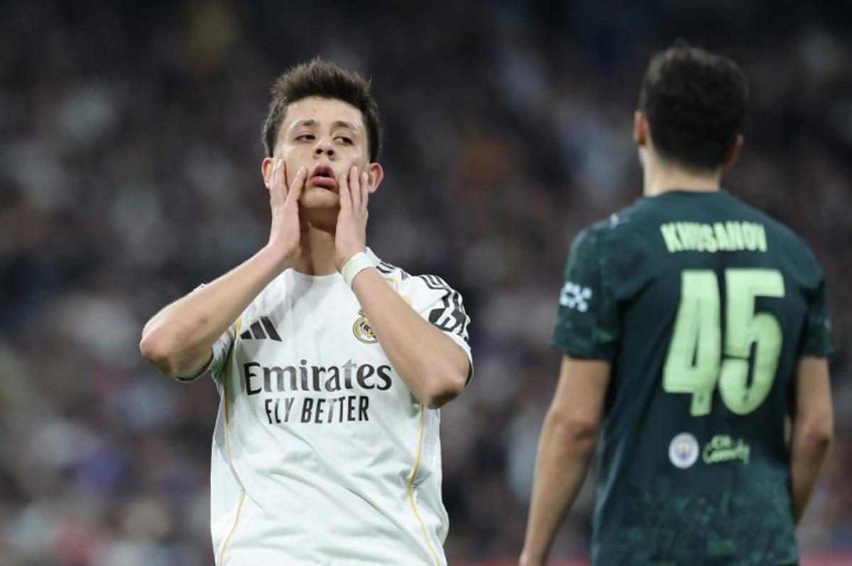 Real Madrid's Turkish midfielder #15 Arda Guler (L) reacts during the UEFA Champions League last 16 first leg football match between Real Madrid CF and Manchester City at Santiago Bernabeu Stadium in Madrid on March 11, 2026.  Thomas COEX / AFP