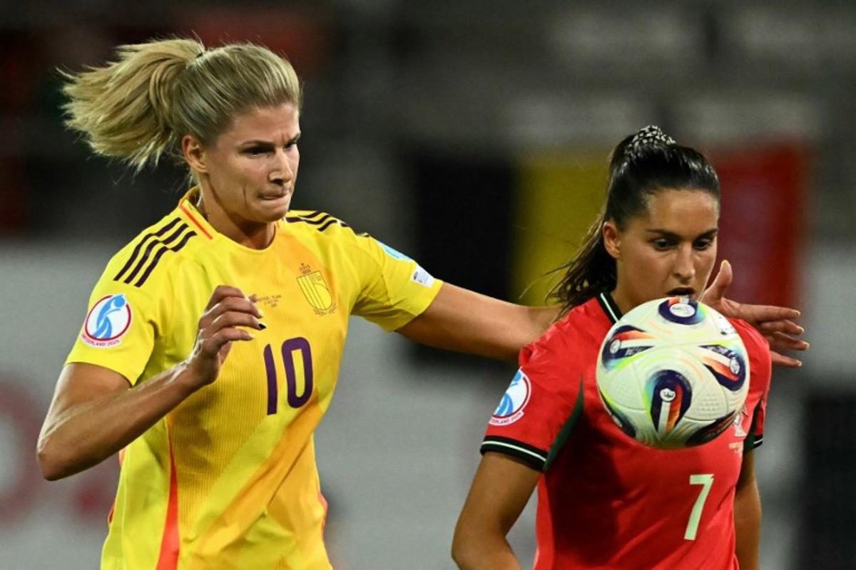 Belgium's midfielder #10 Justine Vanhaevermaet and Portugal's forward #07 Francisca Nazareth eye the ball during the UEFA Women's Euro 2025 Group B football match between Portugal and Belgium at the Stade de Tourbillon in Sion, on July 11, 2025.  Fabrice COFFRINI / AFP