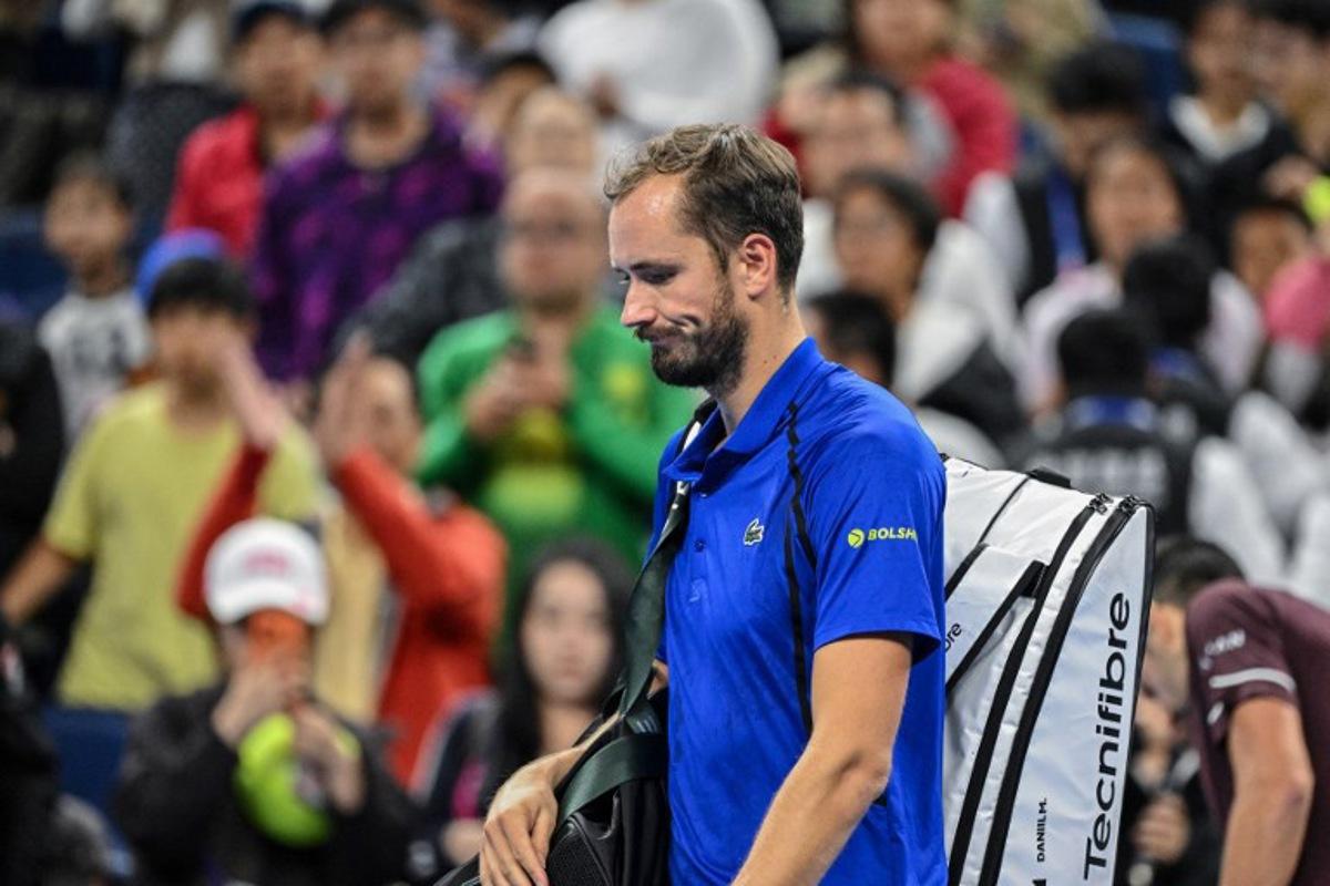 Russia's Daniil Medvedev walks off the court after being disqualified for hitting a ball into the stands, injuring a spectator, during the men's singles semi-final against Serbia's Novak Djokovic at the China Open tennis tournament in Beijing on October 5, 2026.  GREG BAKER / AFP