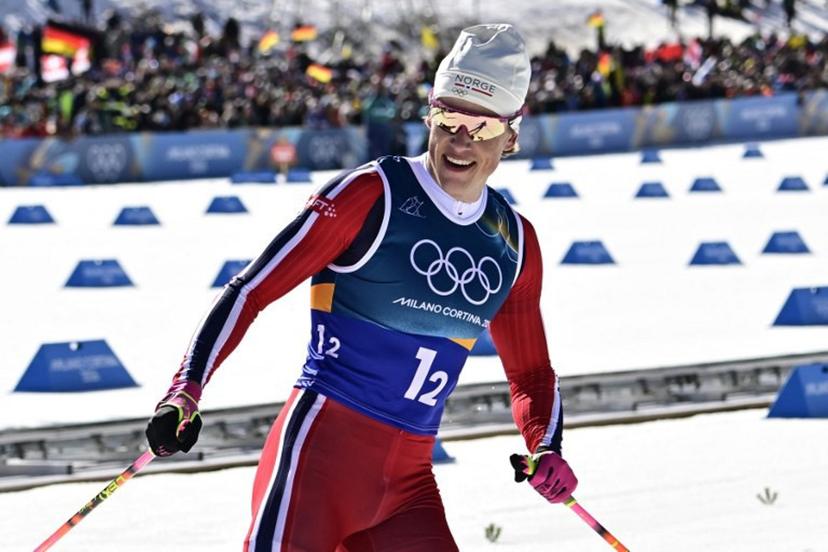 Norway's Johannes Hoesflot Klaebo celebrates after crossing the finish line for Norway to win gold during the men's team cross country free sprint final event of the Milano Cortina 2026 Winter Olympic Games at Tesero Cross-Country Skiing Stadium in Lago di Tesero (Val di Fiemme), on February 18, 2026.  Tobias SCHWARZ / AFP