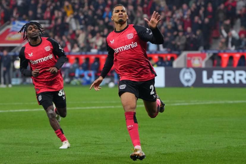 Bayer Leverkusen's French forward #21 Amine Adli (R) celebrates scoring the 3-1 goal with his teammate Dutch defender #30 Jeremie Frimpong during the German first division Bundesliga football match between Bayer 04 Leverkusen and VfL Bochum in Leverkusen, western Germany on March 28, 2025.  Pau BARRENA / AFP