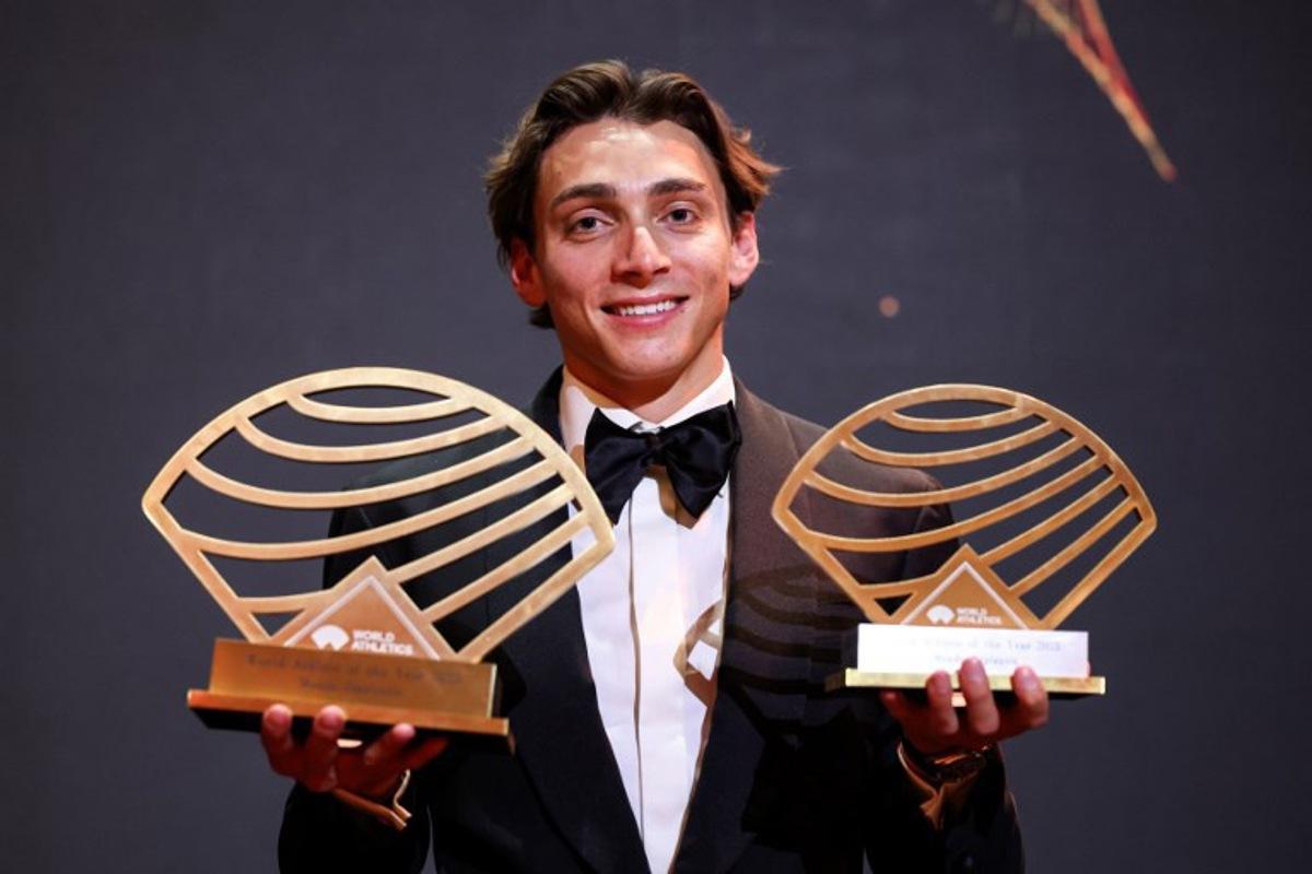 Sweden's world pole vault champion Armand Duplantis poses with the Men's World athlete of the year award and Men's field athlete of the year award during the World Athletics Awards 2025 in Monaco, on November 30, 2025.  Valery HACHE / AFP