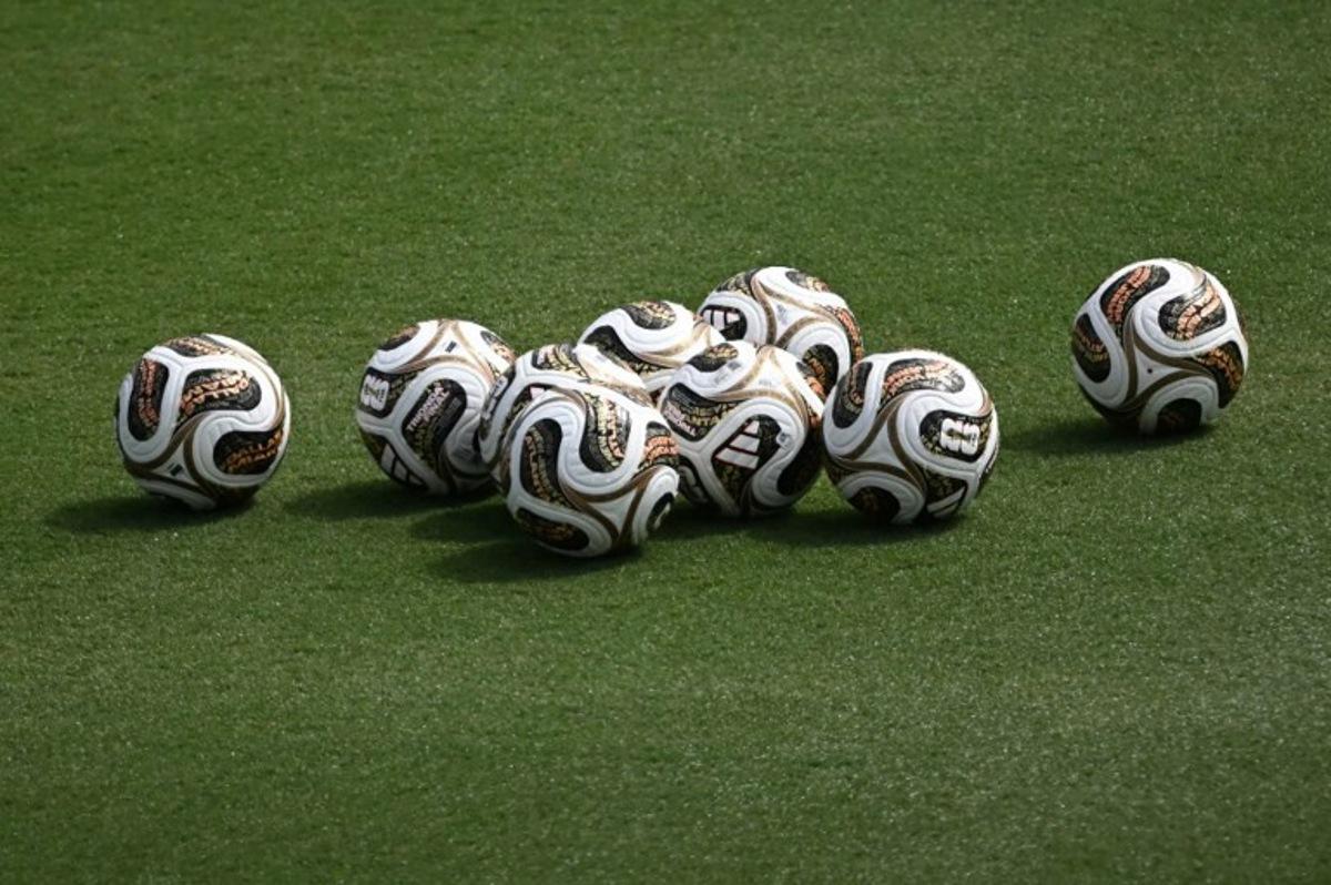 A photo the new official competition footballs for the semi-finals sitting in the pitch at a Spain training session at the at the Cotton Bowl Stadium in Dallas on July 12, 2026, during the 2026 World Cup foorball tournament.   Paul ELLIS / AFP