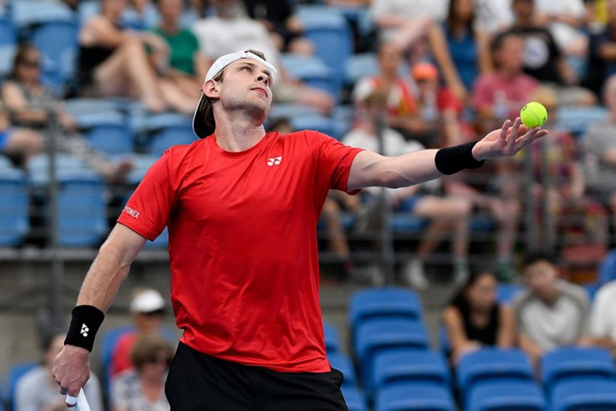 Belgium's Zizou Bergs serves to Canada's Cleeve Harper and Victoria Mboko during their mixed doubles match at the United Cup tennis tournament on Ken Rosewall Arena, Sydney on January 6, 2026.  Izhar KHAN / AFP