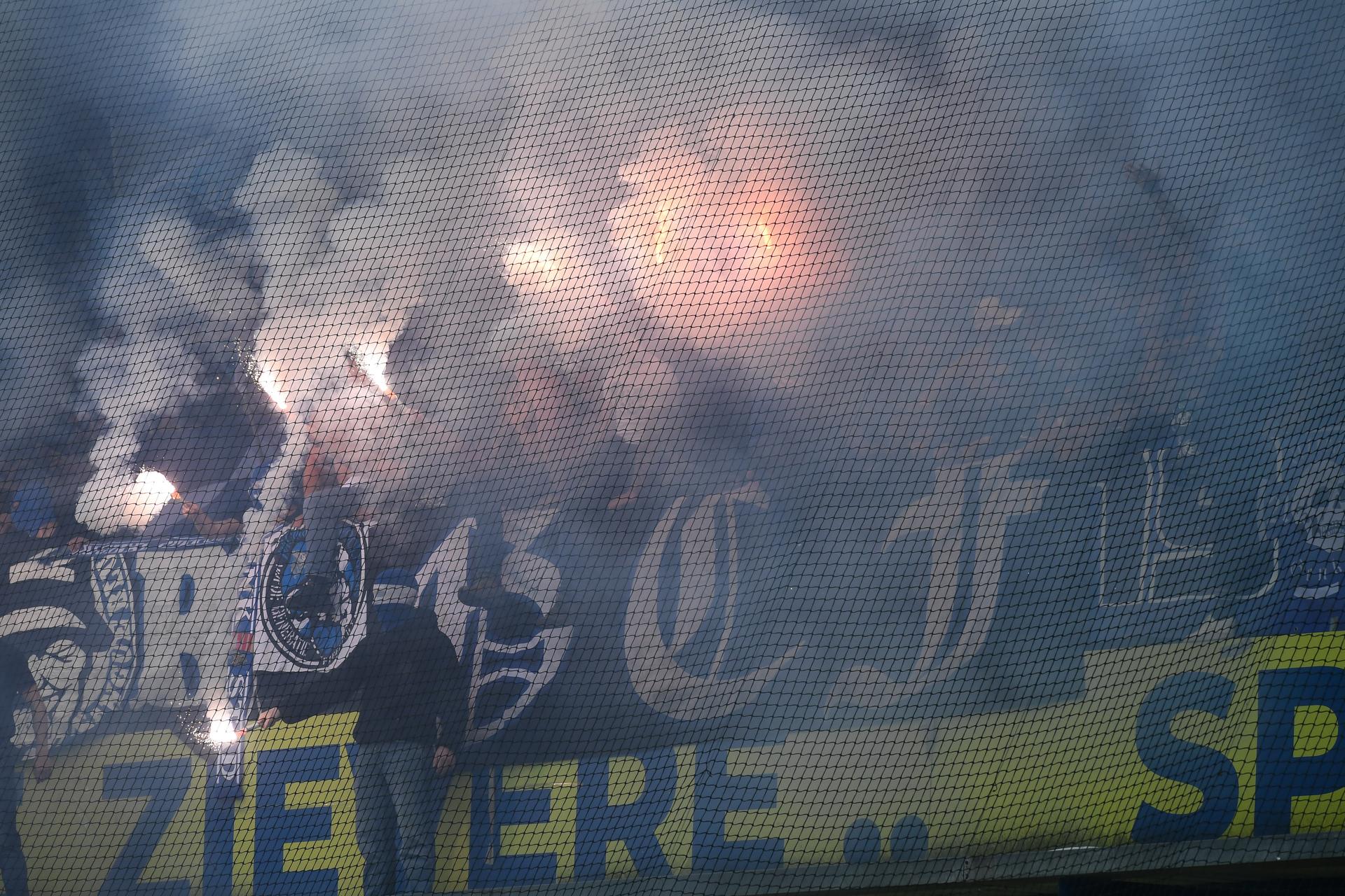 Supporters with fireworks and smoke bombs pictured during a soccer match between Sint-Truidense V.V. and KRC Genk, Sunday 28 September 2025 in Sint-Truiden, on day 9 of the 2025-2026 'Jupiler Pro League' first division of the Belgian championship. BELGA PHOTO JILL DELSAUX