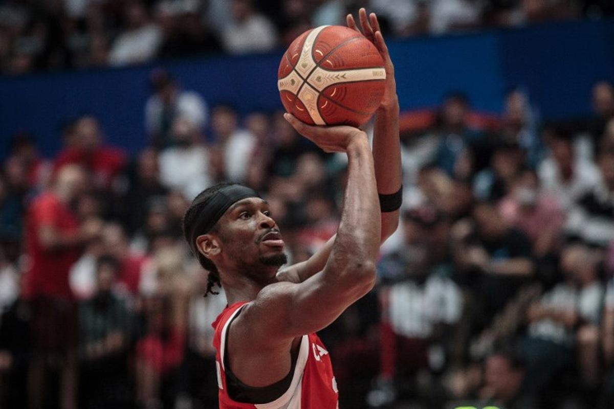 Canada's Shai Gilgeous-Alexander (C) shoots a free-throw during the FIBA Basketball World Cup group L match between Spain and Canda at Indonesia Arena in Jakarta on September 3, 2023.   AFP