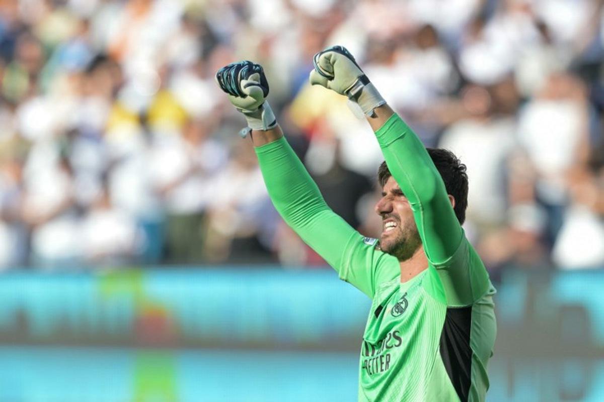 Real Madrid's Belgian goalkeeper #01 Thibaut Courtois reacts after winning the FIFA Club World Cup 2025 quarterfinal football match between Spain's Real Madrid and Germany's Borussia Dortmund at the MetLife stadium in East Rutherford, New Jersey on July 5, 2025.  JUAN MABROMATA / AFP