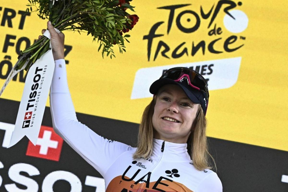UAE Team ADQ's French rider Maeva Squiban celebrates on the podium with the most combative rider's award after the 6th stage (out of 9) of the fourth edition of the Women's Tour de France cycling race, 123.7 km from Clermont-Ferrand to Ambert, in Ambert, central France on July 31, 2025.  JULIEN DE ROSA / AFP