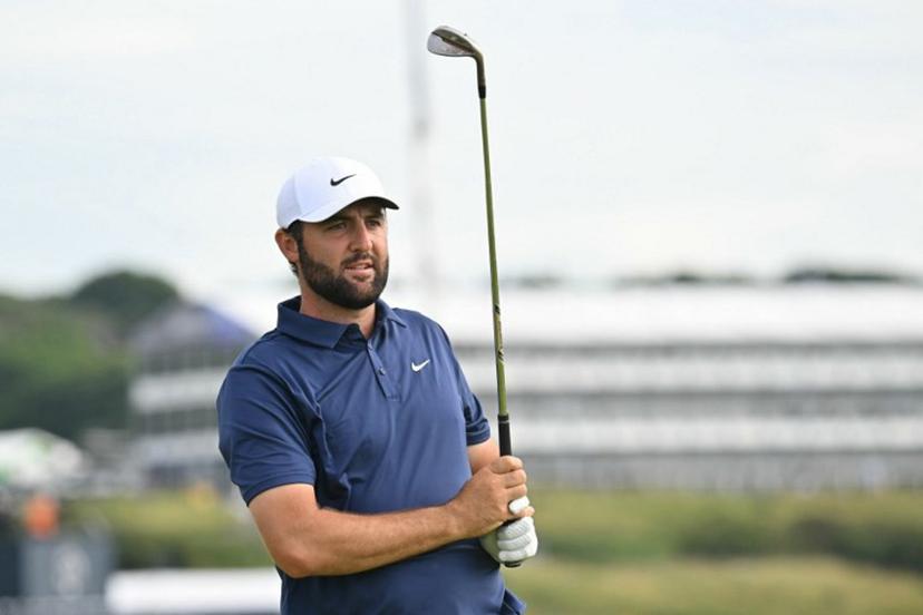 US golfer Scottie Scheffler watches his approach shot from the 15th fairway on day four of the 153rd Open Championship at Royal Portrush golf club in Northern Ireland on July 20, 2025.  ANDY BUCHANAN / AFP