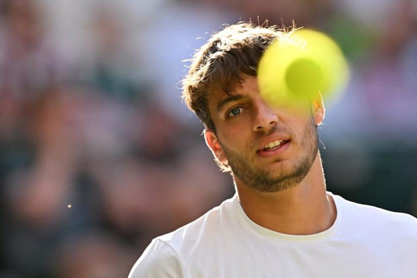Italy's Flavio Cobolli eyes the ball as he plays against Serbia's Novak Djokovic during their men's singles quarter-final tennis match on the tenth day of the 2025 Wimbledon Championships at The All England Lawn Tennis and Croquet Club in Wimbledon, southwest London, on July 9, 2025.  Glyn KIRK / AFP