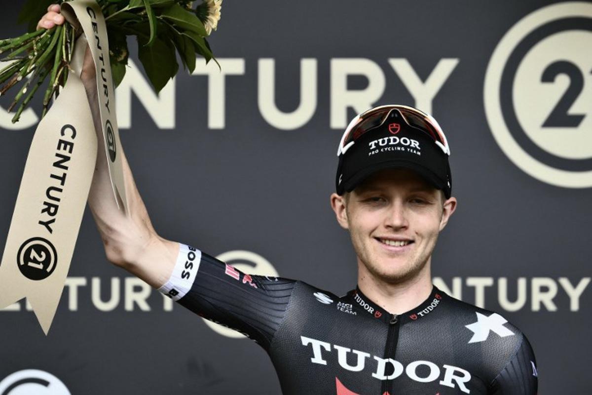 Tudor Pro Cycling Team's Australian rider Michael Storer celebrates on the podium with the most combative rider's award after the 15th stage of the 112th edition of the Tour de France cycling race, 169.3 km between Muret and Carcassonne, southwestern France, on July 20, 2025.  Marco BERTORELLO / AFP