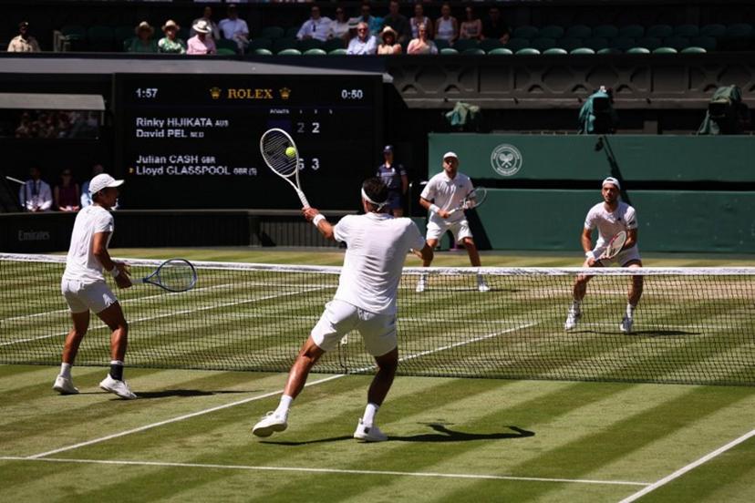 Australia's Rinky Hijikata playing with Netherlands' David Pel (front) returns the ball to Britain's Julian Cash and Britain's Lloyd Glasspool during their men's doubles final tennis match on the thirteenth day of the 2025 Wimbledon Championships at The All England Lawn Tennis and Croquet Club in Wimbledon, southwest London, on July 12, 2025.  HENRY NICHOLLS / AFP