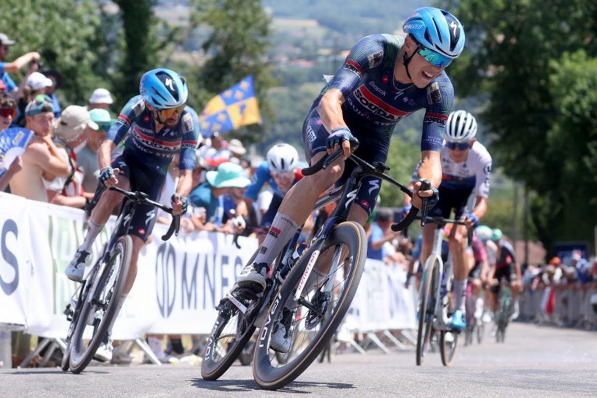 Soudal Quick-Step's French rider Paul Magnier (C) competes in the men's Elite Road Race, part of the French Cycling Championship 2026, near La Tour du Pin, central-eastern France on June 28, 2026.  Alex MARTIN / AFP