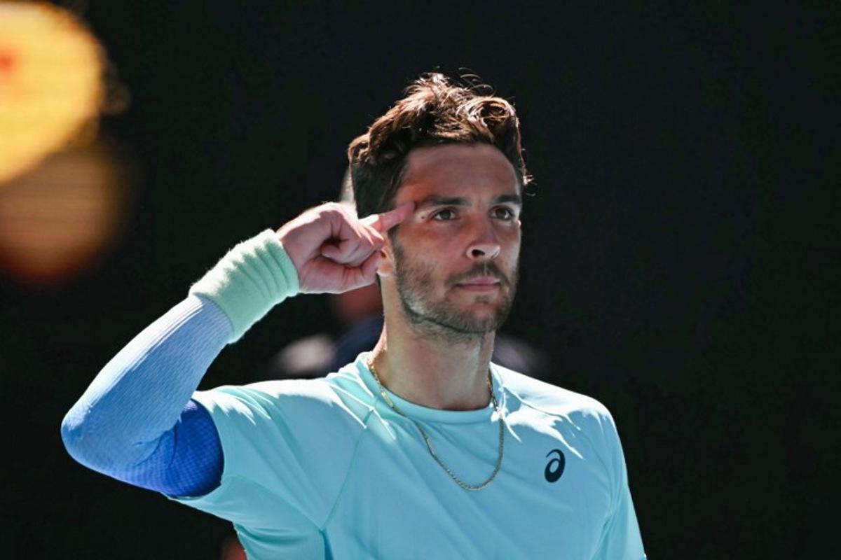 Italy's Lorenzo Musetti celebrates victory against USA's Taylor Fritz in their men's singles match on day nine of the Australian Open tennis tournament in Melbourne on January 26, 2026.   WILLIAM WEST / AFP