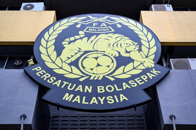 The logo of the Malaysian football association (FAM) is pictured at the FAM's headquarters in Kuala Lumpur on January 28, 2026. The Malaysian football association's entire executive committee resigned on January 28, due to an ongoing eligibility scandal linked to forged documents used in Asian Cup qualifying games. Mohd Rasfan / AFP