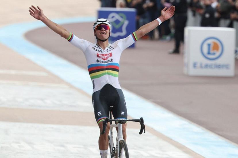 Alpecin - Deceuninck team's Dutch rider Mathieu Van Der Poel celebrates as he cycles past the finish line to win the 121st edition of the Paris-Roubaix one-day classic cycling race, 260km between Compiegne and Roubaix, northern France, on April 7, 2024.  FRANCOIS LO PRESTI / AFP