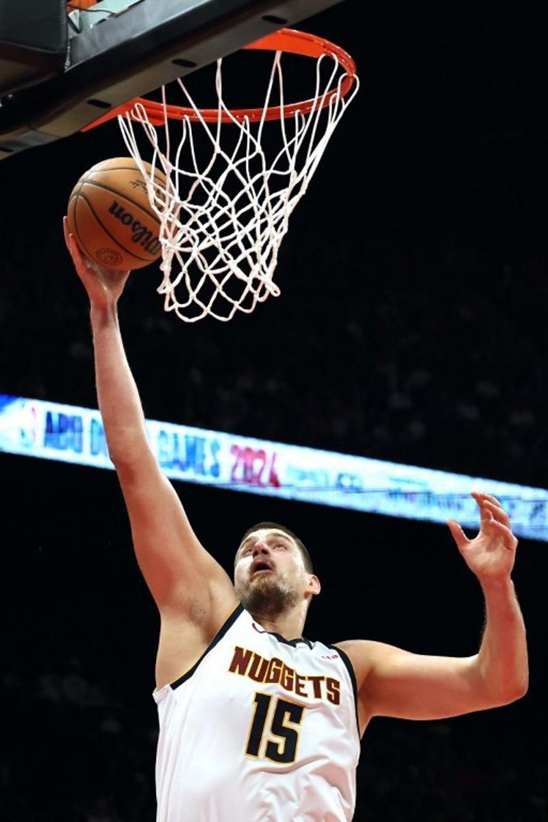 Denver Nuggets' center #15 Nikola Jokic jumps to shoot during the NBA Preseason game between the Boston Celtics and the Denver Nuggets at the Etihad Arena in Abu Dhabi on October 6, 2024.  Fadel Senna / AFP
