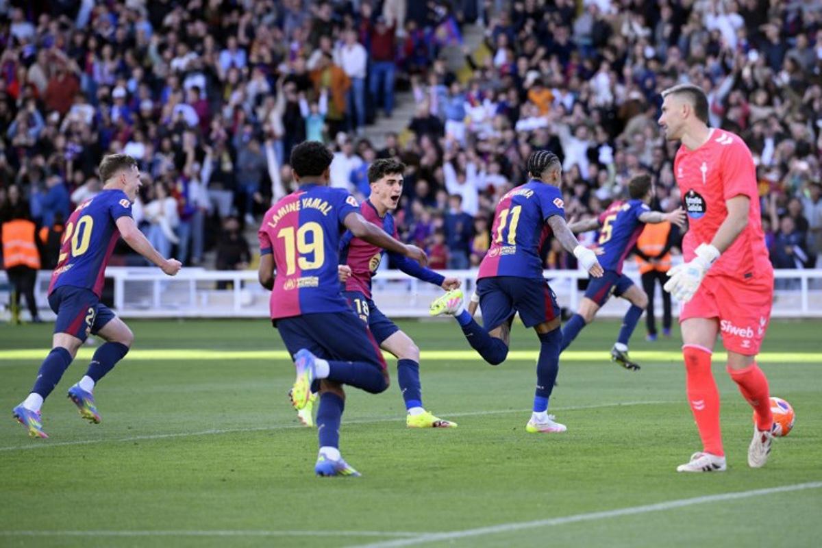 Barcelona's Brazilian forward #11 Raphinha celebrates scoring his team's fourth goal, from the penalty spot, during the Spanish league football match between FC Barcelona and RC Celta de Vigo at the Estadi Olimpic Lluis Companys in Barcelona on April 19, 2025.  Josep LAGO / AFP