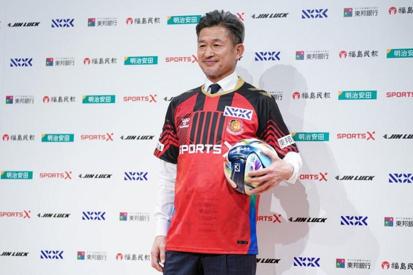 Japanese footballer Kazuyoshi Miura, 58, shows his Fukushima United FC uniform during a press conference in Tokyo on January 9, 2026.  Kazuhiro NOGI / AFP