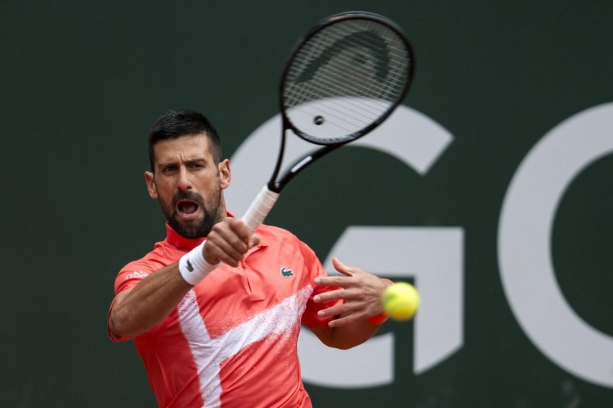 Serbia's Novak Djokovic returns a ball to Hungary's Marton Fucsovics during their match at the ATP 250 Geneva Open tennis tournament in Geneva on May 21, 2025.   FABRICE COFFRINI / AFP