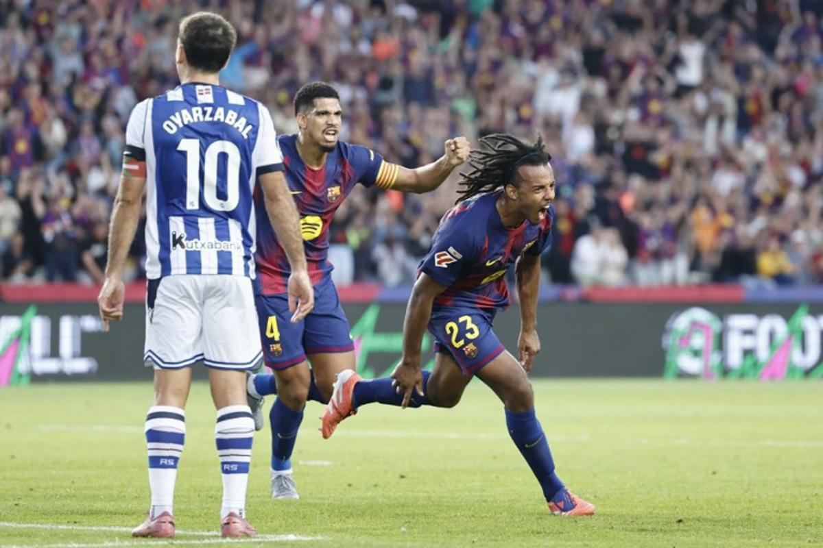 Barcelona's French defender #23 Jules Kounde (R) celebrates scoring his team's first goal during the Spanish league football match between FC Barcelona and Real Sociedad at the Estadi Olimpic Lluis Companys in Barcelona on September 28, 2025.  Josep LAGO / AFP
