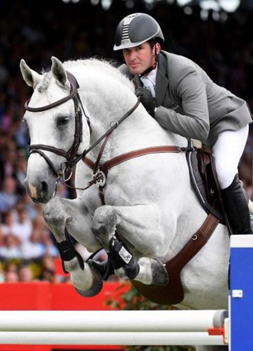 Philipp Weishaupt of Germany jumps with his horse LB Convall over an obstacle in the speed and handiness competition during the 1st round of the Rolex horse jumping Grand Prix in Aachen, Germany, on July 17, 2016. 
PATRIK STOLLARZ / AFP