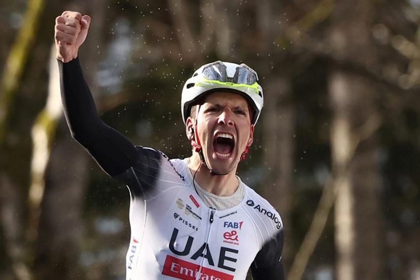 UAE Team Emirates XRG's Portuguese rider Joao Almeida celebrates after crossing the finish line to win the 4th stage of the Paris-Nice cycling race, 163,4 km between Vichy and La Loge des Gardes, on March 12, 2025.  Anne-Christine POUJOULAT / AFP