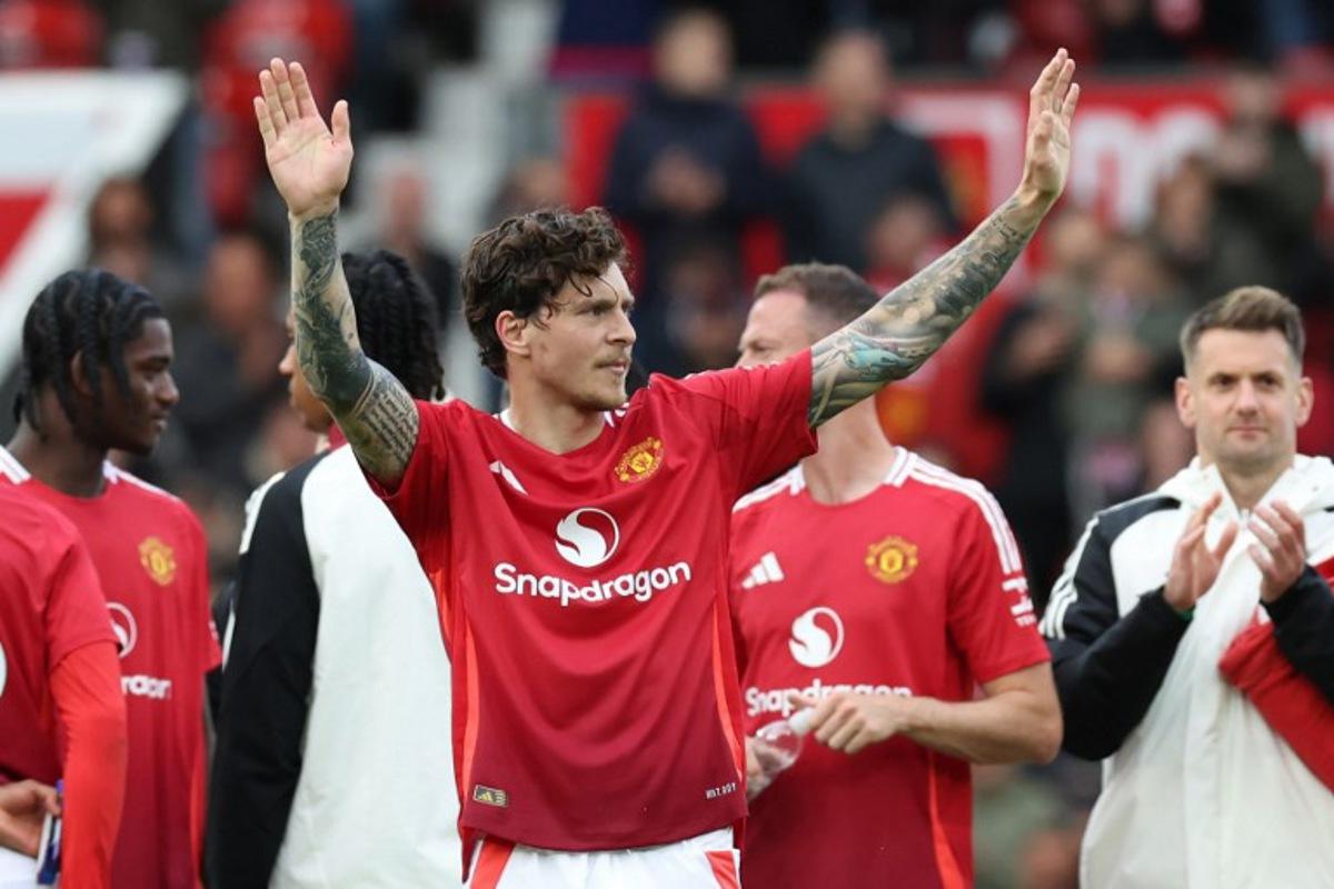 Manchester United's Swedish defender #02 Victor Lindelof gestures to supporters after playing his final game for United after the English Premier League football match between Manchester United and Aston Villa at Old Trafford in Manchester, north west England, on May 25, 2025. United won the game 2-0. Darren Staples / AFP