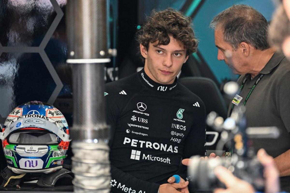 Mercedes' Italian driver Kimi Antonelli (L) speaks with his dad Marco Antonelli (R) before the qualifying session ahead of the Formula One British Grand Prix at the Silverstone motor racing circuit in Silverstone, central England, on July 4, 2026.  PETER POWELL / POOL / AFP