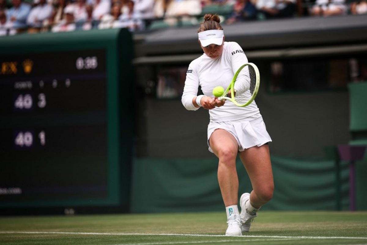 Czech Republic's Barbora Krejcikova plays a backhand return to USA's Emma Navarro during their women's singles third round tennis match on the sixth day of the 2025 Wimbledon Championships at The All England Lawn Tennis and Croquet Club in Wimbledon, southwest London, on July 5, 2025.  HENRY NICHOLLS / AFP