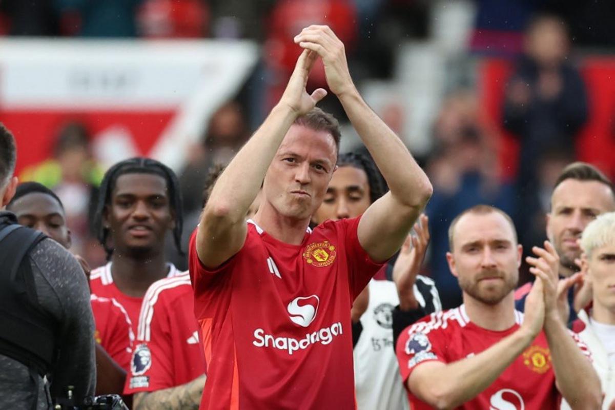 Manchester United Northern Irish defender #35 Jonny Evans applauds supporters after playing his final game for United after the English Premier League football match between Manchester United and Aston Villa at Old Trafford in Manchester, north west England, on May 25, 2025. United won the game 2-0. Darren Staples / AFP