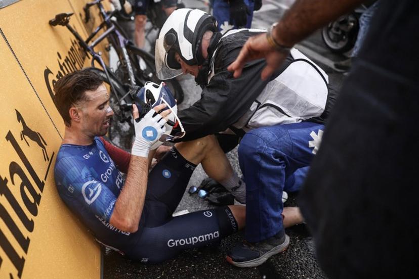 Groupama - FDJ team's French rider Cyril Barthe receives medical assistance after a mass crash metres from the finish line of the 112th edition of the Tour de France cycling race, 160.4 km between Bollene and Valence, southern France, on July 23, 2025.  Anne-Christine POUJOULAT / AFP