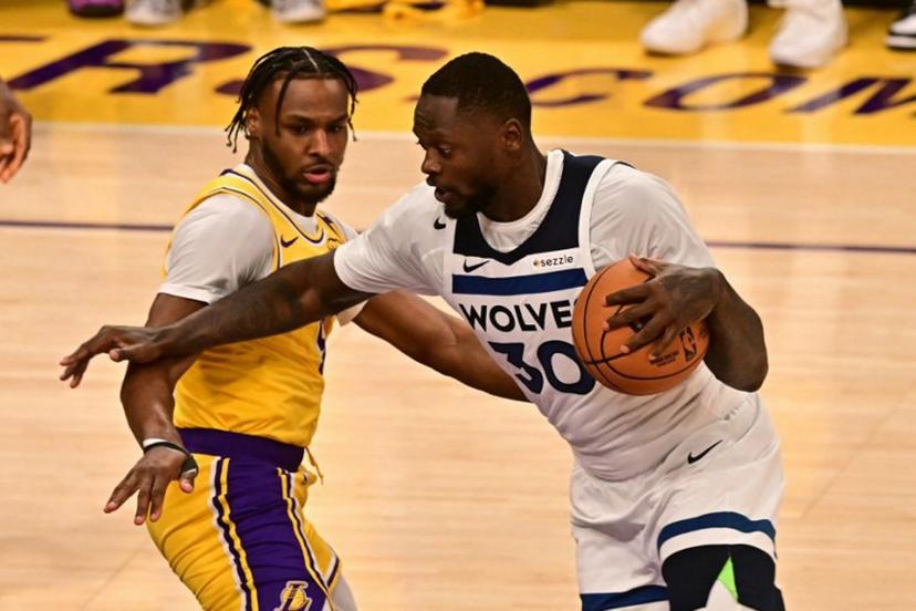 Minnesota Timberwolves' US power forward #30 Julius Randle dribbles past Los Angeles Lakers' US guard #09 Bronny James during the NBA game season opener between the Los Angeles Lakers and the Minnesota Timberwolves at Crypto Arena in Los Angeles on October 22, 2024.  Frederic J. Brown / AFP