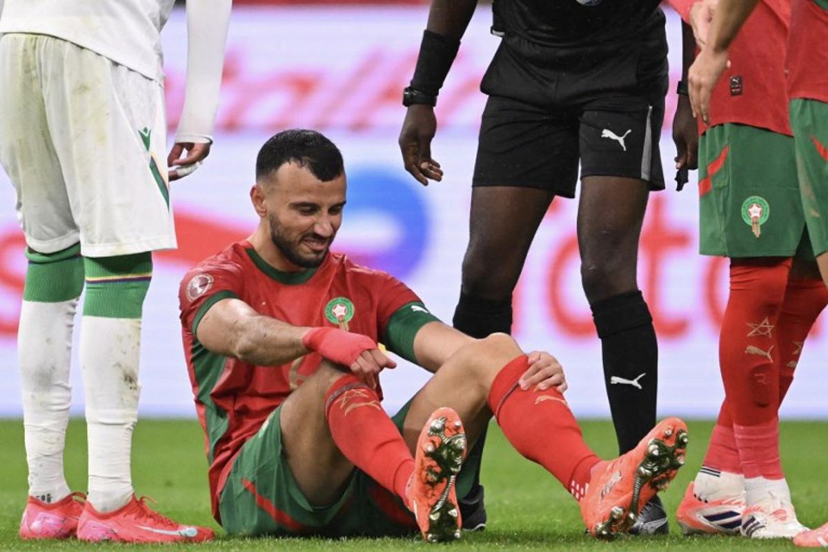 Morocco's defender #06 Romain Ghanem Saiss grimaces during the Africa Cup of Nations (CAN) group A  football match between Morocco and Comoros at Prince Moulay Abdellah Stadium in Rabat on December 21, 2025.   SEBASTIEN BOZON / AFP