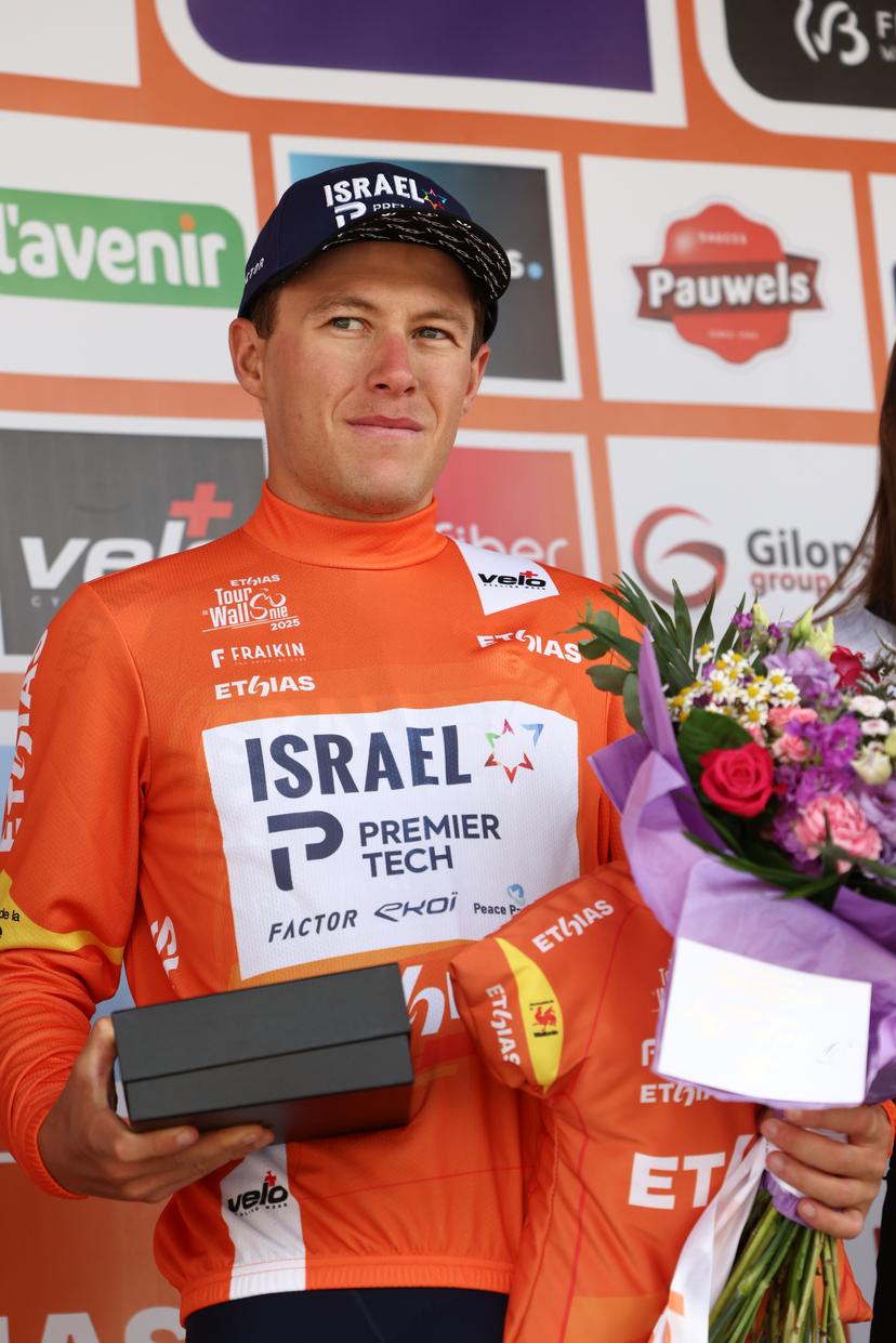 New Zealander Corbin John Strong of Israel-Premier Tech wearing the orange jersey of leader in the overall ranking after the fourth stage of the Tour De Wallonie cycling race, from Welkenraedt to Seraing (163,3 km), on Tuesday 29 July 2025. BELGA PHOTO BRUNO FAHY