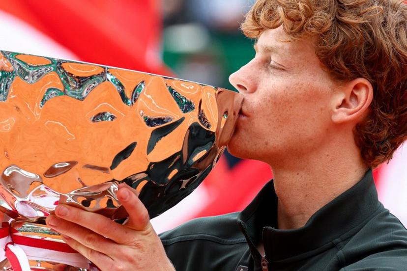 Italy's Jannik Sinner kisses the trophy as he celebrates on the podium after winning the Monte Carlo ATP Masters Series Tournament final tennis match against Spain's Carlos Alcaraz on Court Rainier III at the Monte-Carlo Country Club in Roquebrune-Cap-Martin, south-eastern France on April 12, 2026.  Valery HACHE / AFP