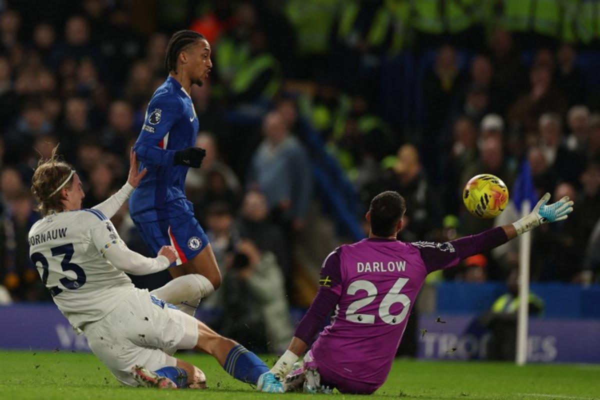 Chelsea's Brazilian striker #20 Joao Pedro (2L) shoots to score the opening goal of the English Premier League football match between Chelsea and Leeds United at Stamford Bridge in London on February 10, 2026.  Adrian Dennis / AFP