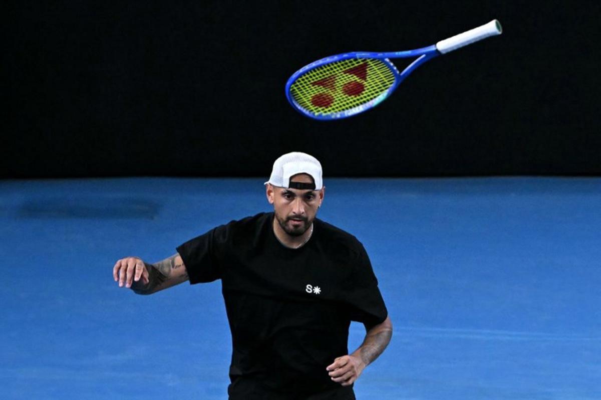 Australia's Nick Kyrgios throws his racket during his men's doubles match against compatriot Jason Kubler and Marc Polmans on day five of the Australian Open tennis tournament in Melbourne on January 22, 2026.  WILLIAM WEST / AFP