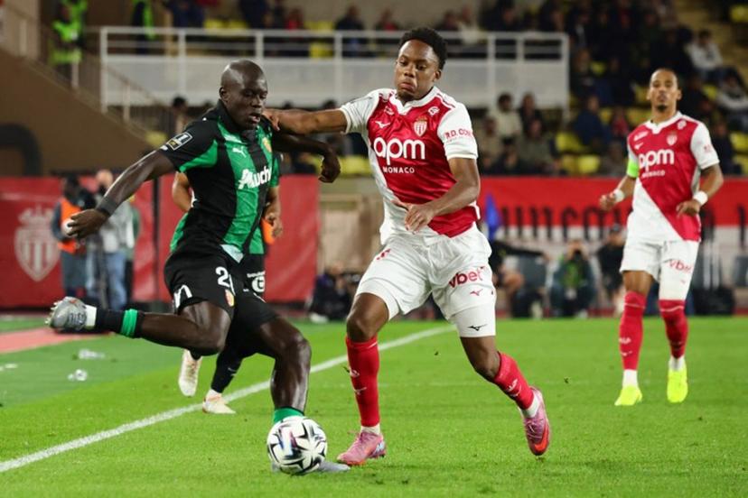 Lens' French defender #20 Malang Sarr (L) fights for the ball with Monaco's French forward #21 Lucas Michal during the French L1 football match between AS Monaco and RC Lens at the Stade Louis II in the Principality of Monaco on November 8, 2025.  Clement MAHOUDEAU / AFP