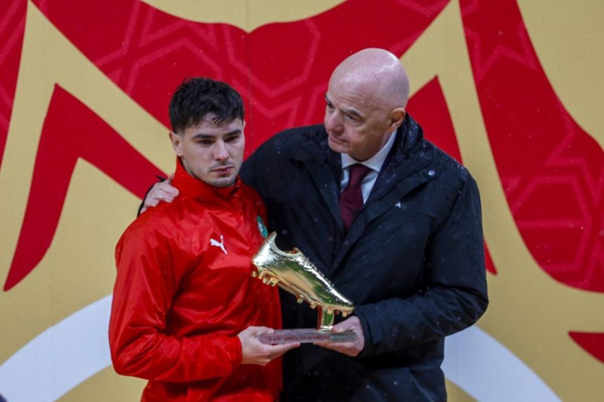 Morocco's forward #10 Brahim Diaz receives the Golden Boot from FIFA President Gianni Infantino during presentation ceremony at the end of the Africa Cup of Nations (CAN) final football match between Senegal and Morocco at the Prince Moulay Abdellah Stadium in Rabat on January 18, 2026.  Abdel Majid BZIOUAT / AFP