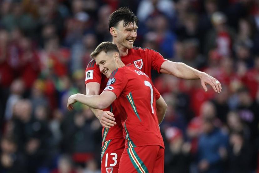 Wales' forward #13 Kieffer Moore (L) celebrates with Wales' midfielder #07 David Brooks (R) after scoring their third goal during the 2026 World Cup Group J qualifier football match between Wales and Liechtenstein, at Cardiff City Stadium, in Cardiff, on June 6, 2025.   Darren Staples / AFP