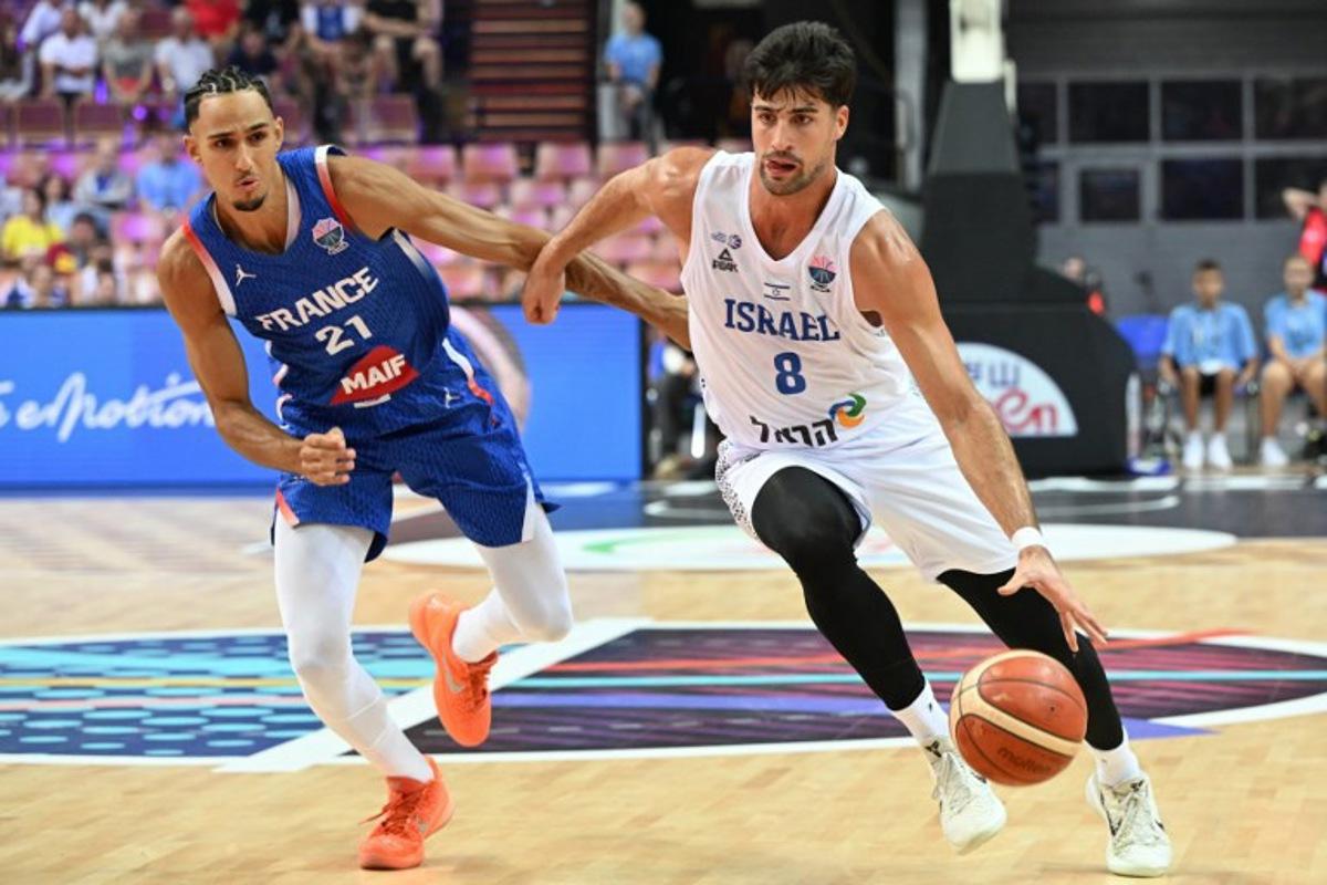 France's small forward #21 Zaccharie Risacher (L) and Israel's forward #08 Deni Avdija (R) vie during the FIBA EuroBasket 2025 Group D basketball match between Israel and France at the Spodek Arena in Katowice, Poland on August 31, 2025.  Sergei GAPON / AFP