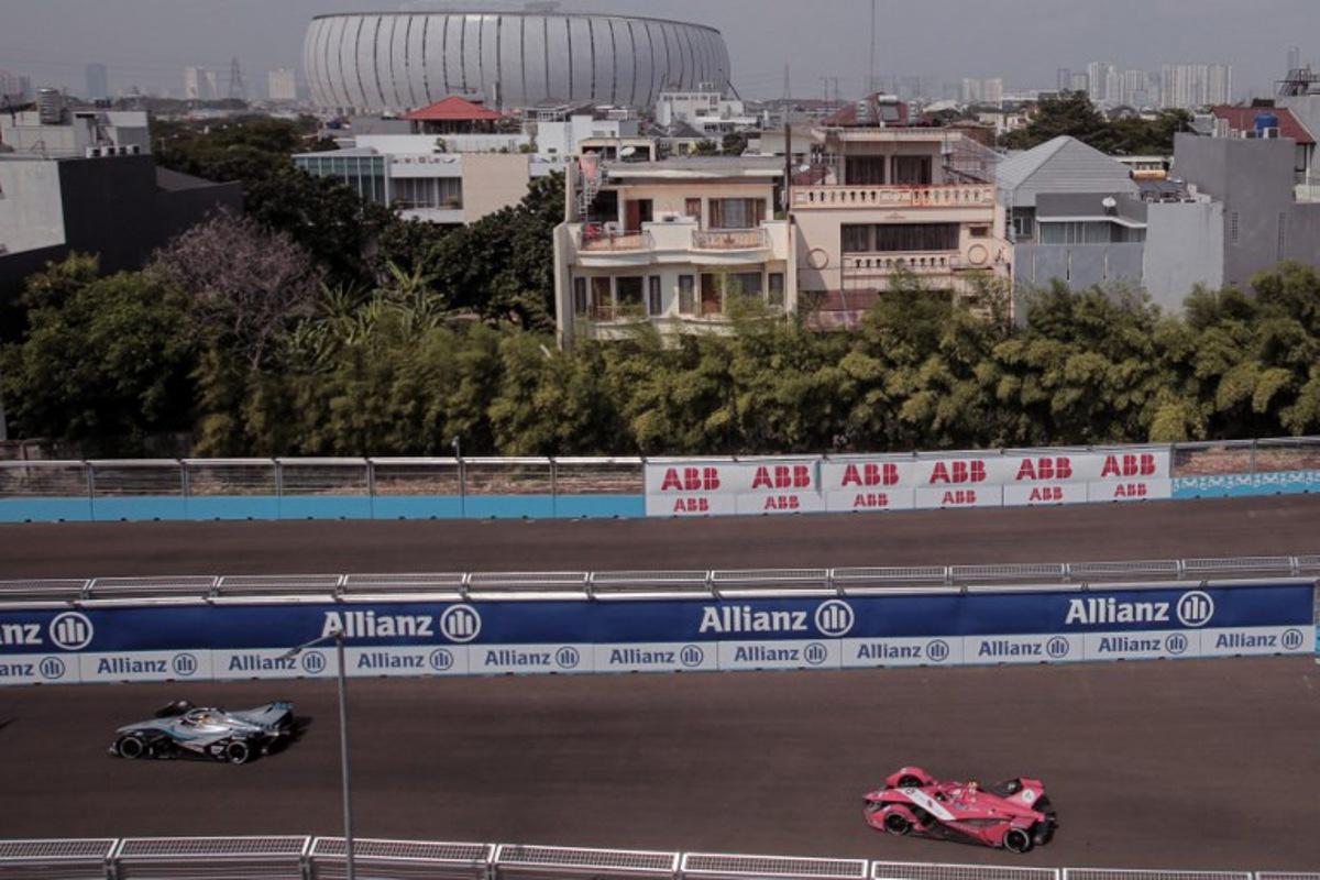Mercedes EQ Formule E Team driver Belgian Stoffel Vandoorne (L) and Avalanche Andretti Formula E driver British Jake Dennis (R) compete in the Formula E qualifying session at the Jakarta Formula E circuit in Jakarta on June 4, 2022.  POPOH RIA / AFP