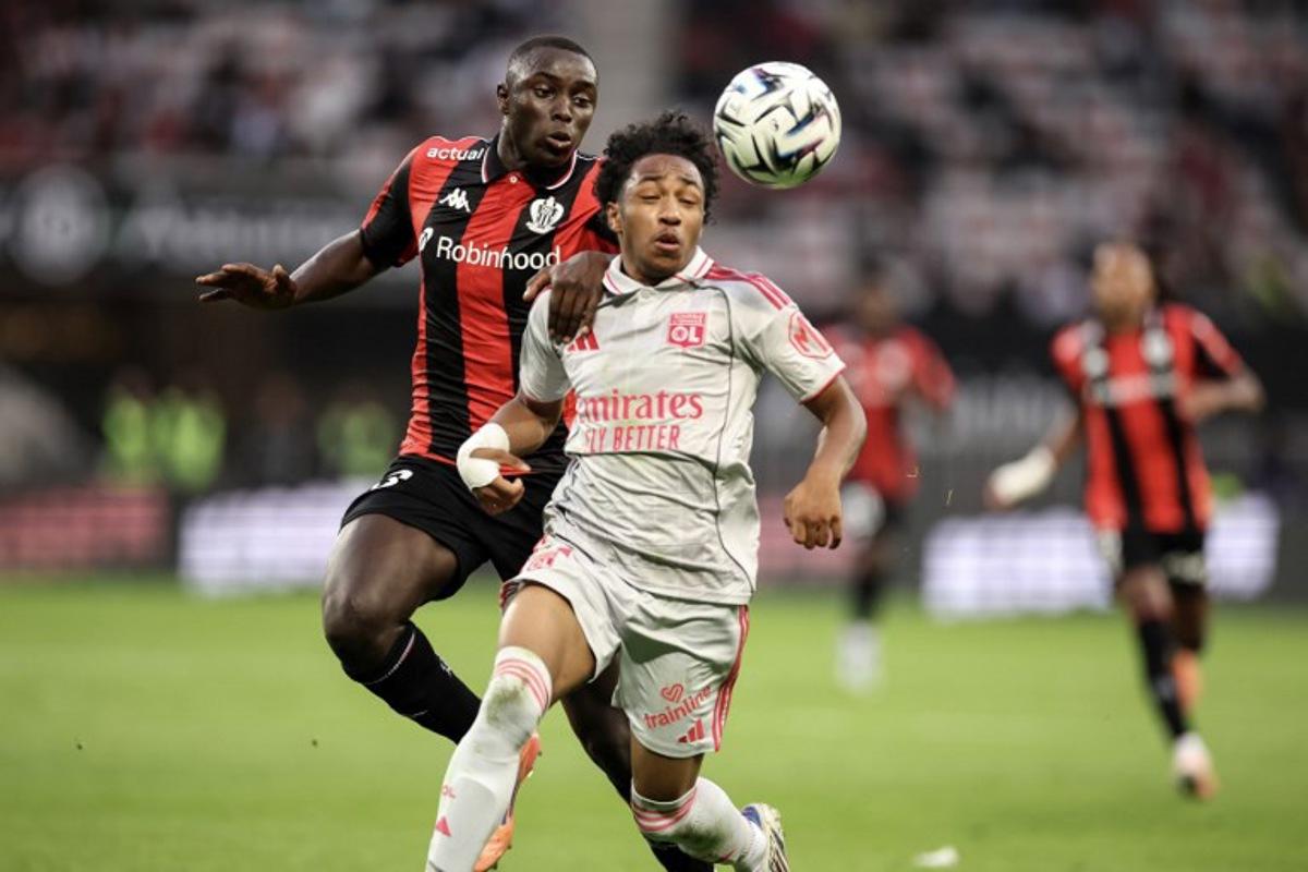 Nice' Senegalese defender #33 Antoine Mendy (L) fights for the ball with Lyon's Belgian forward #11 Malick Fofana (R) during the French L1 football match between OGC Nice and Olympique Lyonnais at the Allianz Riviera Stadium in Nice, south-eastern France on October 18, 2025.  Valery HACHE / AFP