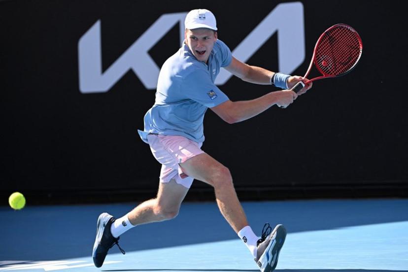 USA's Jenson Brooksby hits a return against USA's Tommy Paul during their men's singles match on day six of the Australian Open tennis tournament in Melbourne on January 21, 2023.  WILLIAM WEST / AFP
