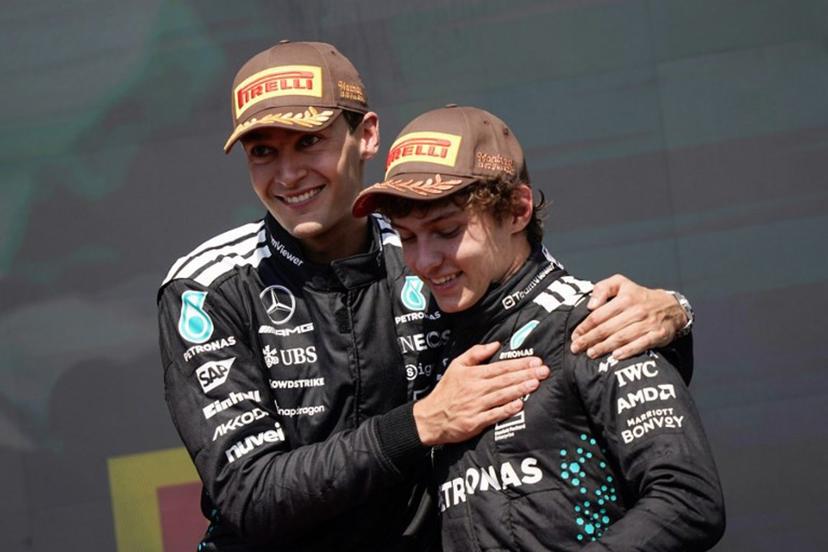 (L/R) Race winner Mercedes' British driver George Russell celebrates with teammate and third place finisher Mercedes' Italian driver Kimi Antonelli on the podium after the 2025 Formula 1 Grand Prix du Canada at Circuit Gilles-Villeneuve in Montreal, Canada, on June 15, 2025.   Geoff Robins / AFP