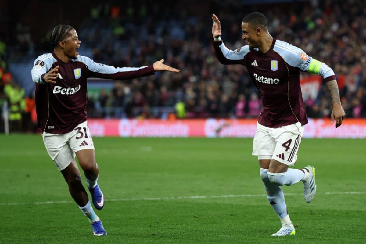 Aston Villa's English defender  #04 Ezri Konsa (R) celebrates scoring the team's fourth goal with Aston Villa's Jamaican midfielder #31 Leon Bailey during the UEFA Europa League, quarter final second-leg football match between Aston Villa and Bologna at Villa Park in Birmingham, central England on April 16, 2026.  Darren Staples / AFP