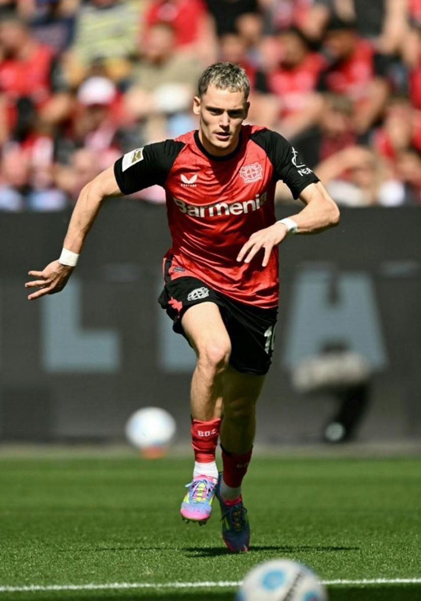 (FILES) Bayer Leverkusen's German midfielder #10 Florian Wirtz chases the ball during the German first division Bundesliga football match between Bayer 04 Leverkusen and FC Augsburg in Leverkusen, western Germany on April 26, 2025. Liverpool have agreed a club-record deal worth up to £116 million ($157 million) to sign Florian Wirtz from Bayer Leverkusen, it was widely reported on Friday, June 13. INA FASSBENDER / AFP