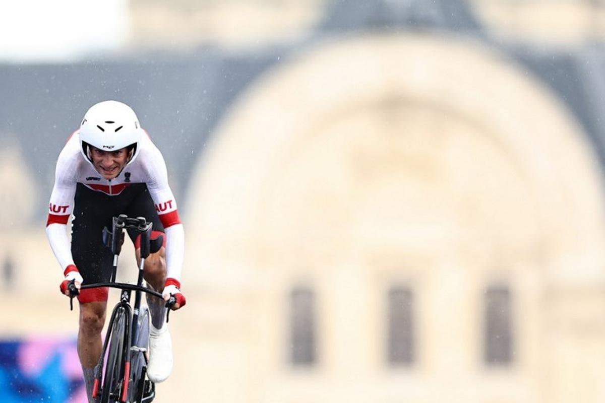 Austria's Felix Grossschartner cycles to cross the finish line of the men's road cycling individual time trial during the Paris 2024 Olympic Games in Paris, on July 27, 2024.  Anne-Christine POUJOULAT / AFP