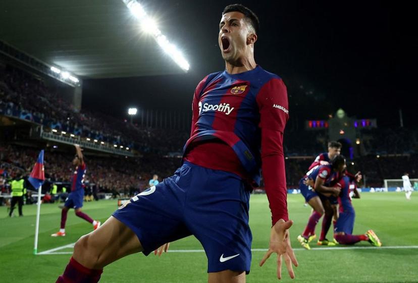 Barcelona's Portuguese defender #02 Joao Cancelo reacts after his team's scores the opening goal during the UEFA Champions League quarter-final second leg football match between FC Barcelona and Paris SG at the Estadi Olimpic Lluis Companys in Barcelona, on April 16, 2024.  FRANCK FIFE / AFP